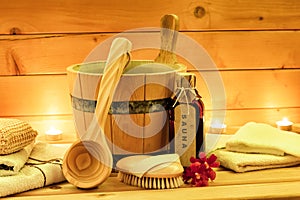 Sauna accessories with sauna oil, wooden bucket, ladle, towels