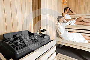 Sauna heater and girls relaxing