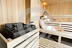 Sauna heater and girls relaxing