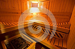 Sauna interior cabin detail with open door and lit lighting