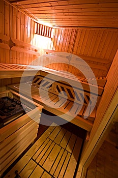 Sauna interior cabin detail with open door and lit lighting