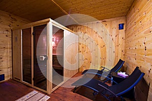 Sauna interior with two sunbeds and cherry wood walls
