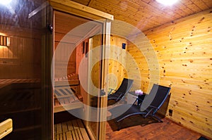 Sauna interior with two sunbeds and cherry wood walls