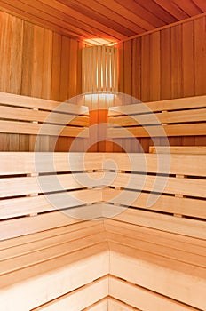 Sauna room. Wooden sauna interior with copper bucket. Bath accessories. Finnish sauna of small size.