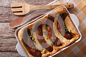 Sausage baked in pastry in a dish close up. Horizontal top view