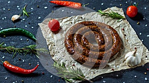 Sausage bbq grill with tomatoes, rosemary, peppers, salt, garlic, spices and vegetables