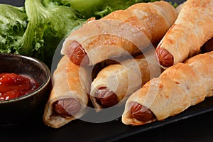 Sausage buns. Soft baked bun dough stuffed with pork sausage for fast food breakfast or coffee break.