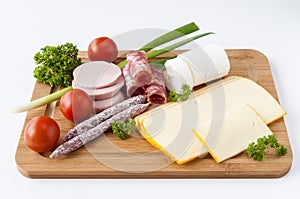Sausage, cheese and vegetables on board