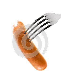 Sausage on fork against white background