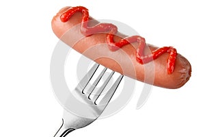 Sausage on fork with ketchup topping