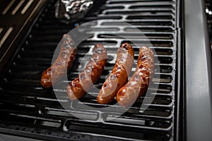 Sausage grilled on a gas grill in closeup