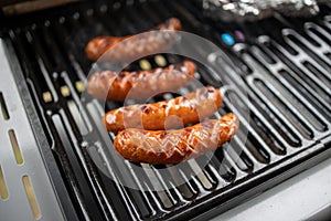 Sausage grilled on a gas grill in closeup