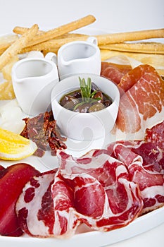 Sausage and jamon snacks with olives, honey and sauce
