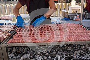 Sausage lined up on a large grill
