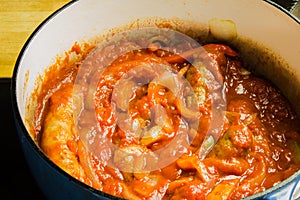 Sausage links cooking with peppers and onions