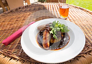 Sausage and mash with gravy in english pub