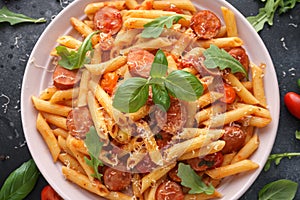 Sausage penne Pasta with tomato sauce and fresh herbs