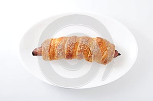 Sausage roll bread on plate on white background