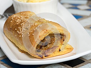 Sausage roll in white plate