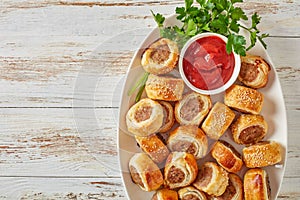 Sausage rolls on a white oval platter