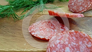 Sausage salami falls on a wooden background