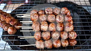 Sausage skewers on the grill grate steel.