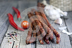 Sausage and spices on vintage wooden boards