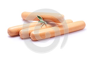 Sausage on white background with herbs and peppercorns