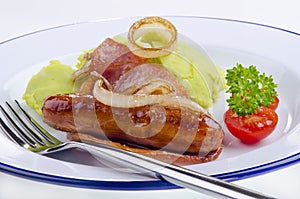 Sausages and bacon with green mashed potato