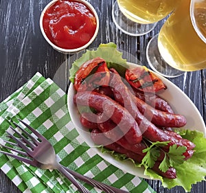 Sausages grilled beer salad recipe parsley beef nutrition on a wooden background lettuce table