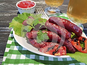 Sausages grilled beer salad recipe parsley nutrition on a wooden background lettuce table