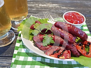 Sausages grilled beer salad recipe homemade nutrition kitchen on a wooden background lettuce table