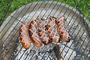 Sausages being barbequed