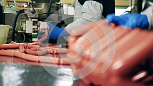 Sausages are being made under factory workers` control