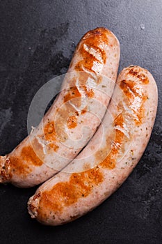 Sausages on a black background grill fried cuts