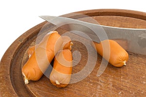 sausages on chopping board on isolated on white background