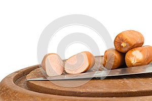 sausages on chopping board on isolated on white background