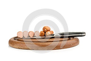 sausages on chopping board on isolated on white background