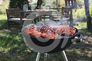 Sausages frying on a grill