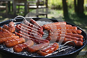 Sausages frying on a grill