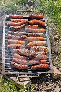 Sausages on the grill, barbecue - grill in nature, gives you an appetite and a delight in the taste of food