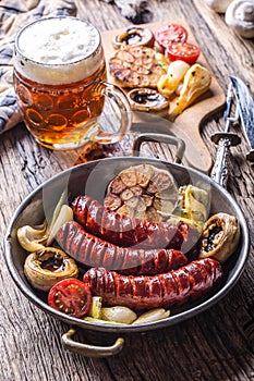 Sausages. Grill sausages. Grilled sausage with beer mushrooms garlic tomatoes and onions