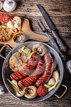 Sausages. Grill sausages. Grilled sausage with mushrooms garlic tomatoes and onions