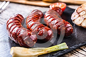 Sausages. Grill sausages. Grilled sausage with mushrooms garlic tomatoes and onions