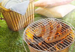 Sausages grilling or glowing hot coals photo