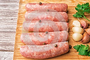 Sausages for grilling on a wooden cutting board