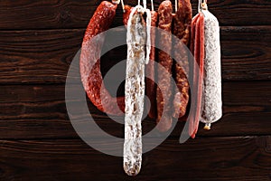 sausages hang from a rack at market. Country dark style. Traditional food. Smoked sausages meat hanging