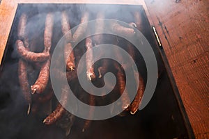 Sausages inside wooden smokers photo