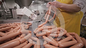 Sausages industrial production. Worker at a manufacturing plant.