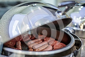 Sausages in marmite on the buffet photo